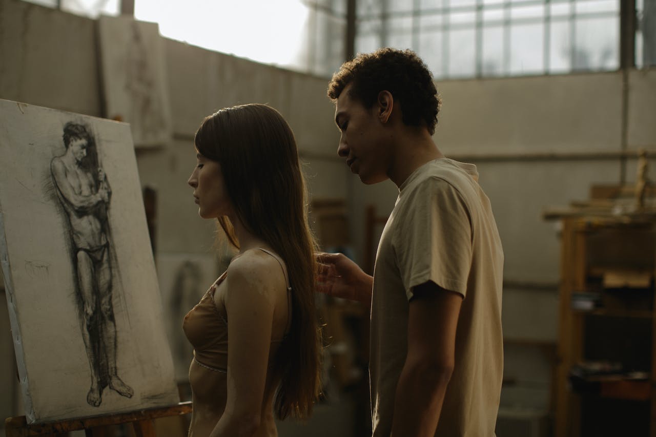 Man in Brown T-shirt Standing Beside Woman in Brown Brassiere