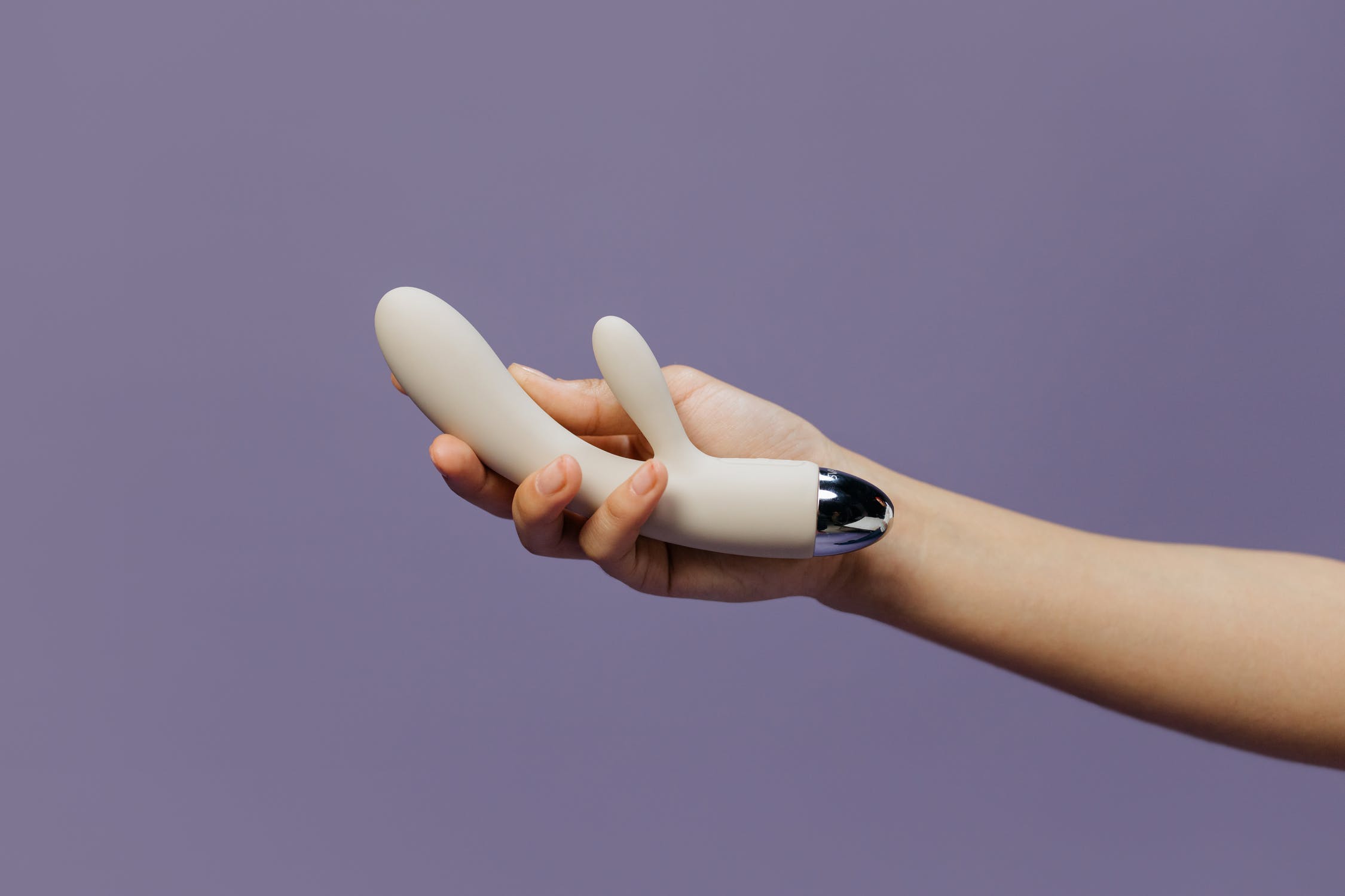 Person holding a vibrator rabbit sex toy